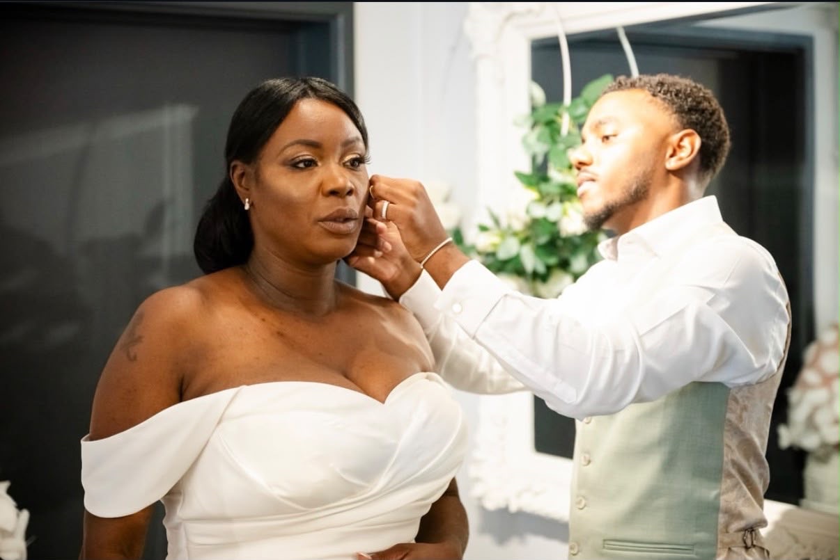 Joshua Vanderpool fastening a client's diamond earring on her wedding morning