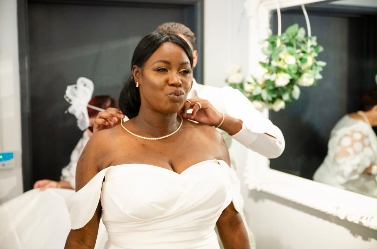 A diamond line necklace being fastened for a bride on her wedding morning
